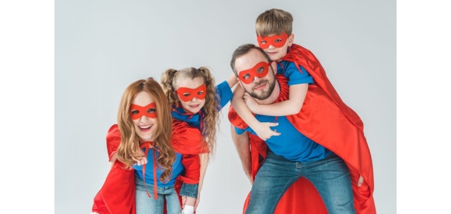 super parents piggybacking kids pretending to be superheroes isolated on grey